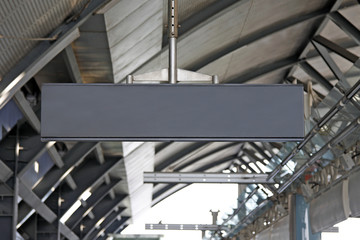 hanging blank metal signpost at the station