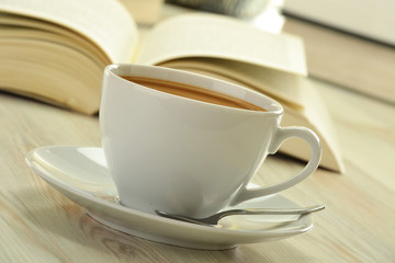 Books cup of coffee on the table