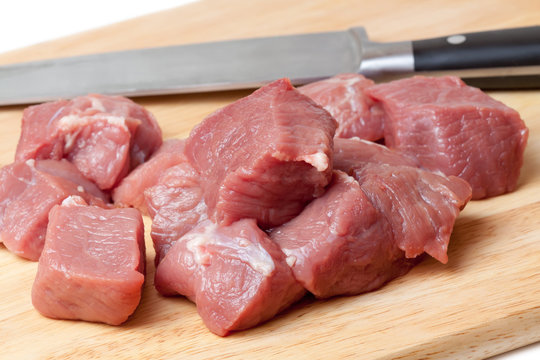 Fresh Raw meat and knife on a cutting board