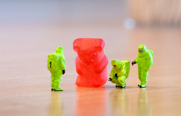 Group of people in protective suit inspecting a jelly bear