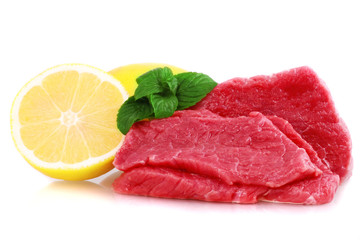 Cut of  beef steak  with lemon slice. Isolated.