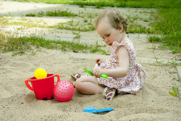 little girl playing in the sandbox