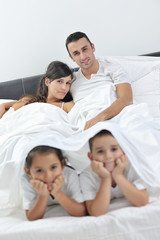 Obraz premium happy young Family in their bedroom