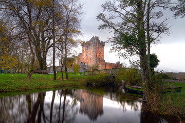 Fototapeta premium Ross Castle reflected at the river at Killarney, Ireland