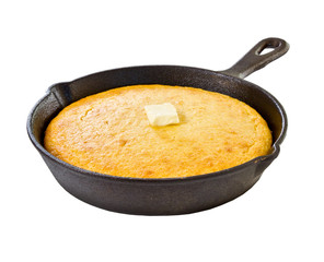Cornbread in iron skillet isolated on white