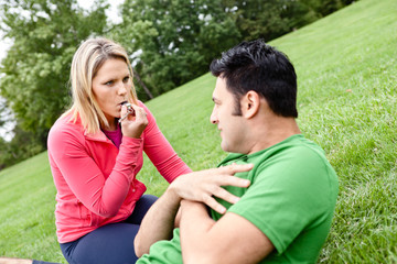 Coach blowing whistle at athlete doing sit ups
