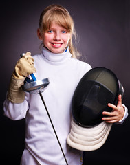 Child in fencing costume holding epee .