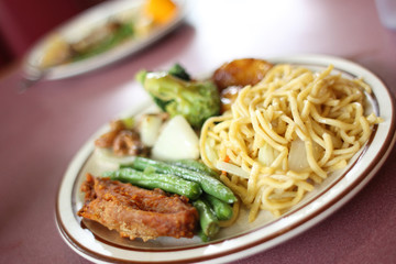 Chinese Chow mein with vegetables and sides.
