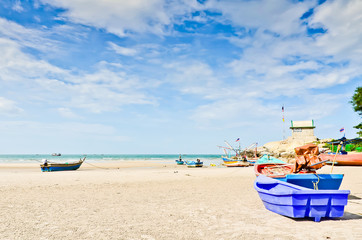 Fototapeta na wymiar Blue plastic boat on sand