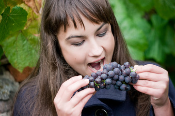 Young woman with grapes