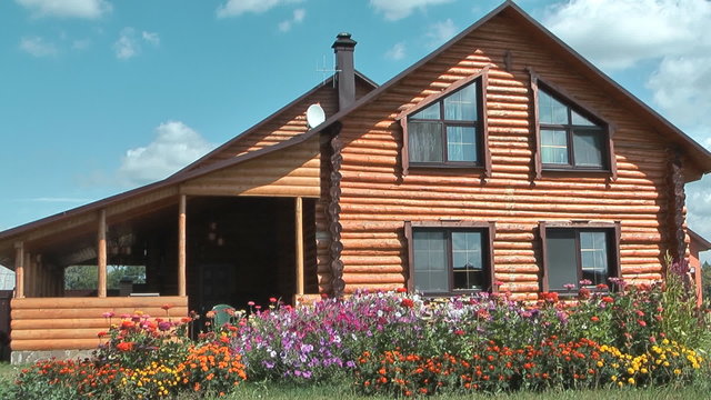 Country log house in the sunny summer day.