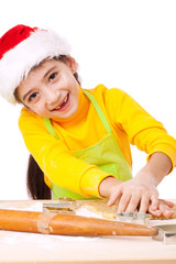 Smiling little girl kneading for Christmas cooking