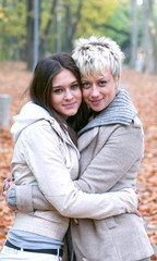 Obraz premium Two girls hugging in nature - Friendship concept