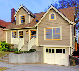 Small new cute brown house with orange doors and windows.