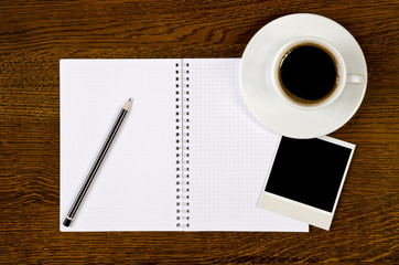 blank notebook with photo frame and coffee cup