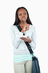 Young student in thoughts about her notes