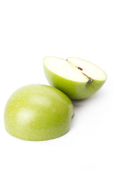 Green apple, two pieces of half green apple on white screen.