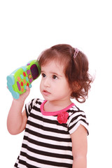 Smiling cute little girl in dress calling by telephone