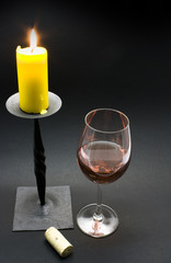 Glass of red wine and candle