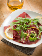 bresaola with arugula salad and olive oil