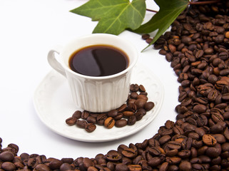 taza de café negro con granos de café tostado