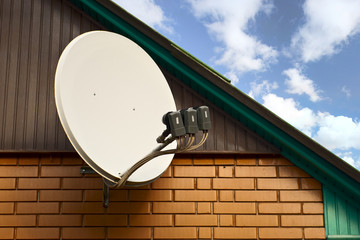 SAT is attached to the wall of the house