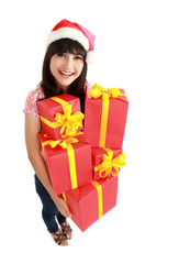 Christmas woman holding gifts wearing Santa hat