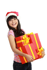 woman in Santa hat holding Christmas gifts