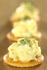 Egg salad served on cracker garnished with dill
