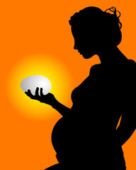 pregnant woman with an egg in his hand