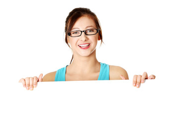 Young girl holding sheet of paper.