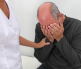 Therapist comforting distressed patient - soft blur