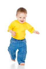 Fun baby boy running. Studio shot.