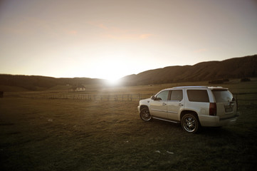 Fototapeta na wymiar off-road vehicles in a field at sunset