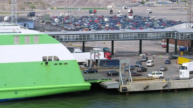 Cars unload from big ferry ship, close-up view, time lapse