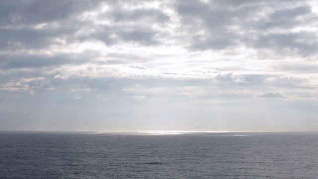 Light pass through clouds at sea, view from ship, time lapse