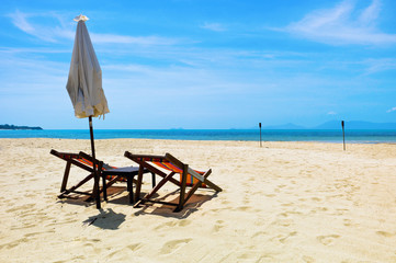 Two beach chairs on a tropical beach