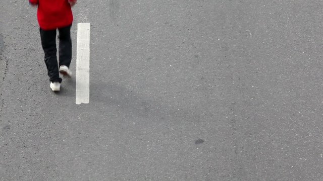 Man in sport wear run on asphalt, another one came after first