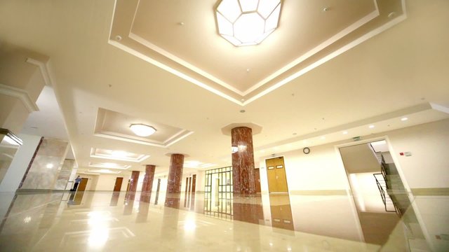 hall with marble floors and column