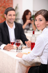 couple at restaurant with woman turned to camera
