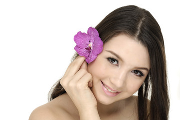 Portrait of very beautiful woman with orchid in her hair