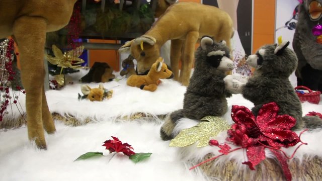 Group of moving plush toy animals on artificial snow