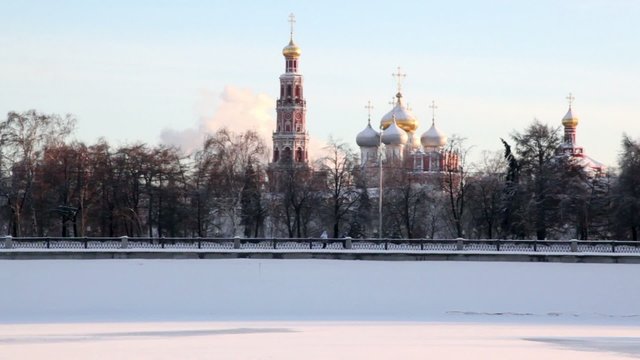 Novodevichy Convent among trees on embankment