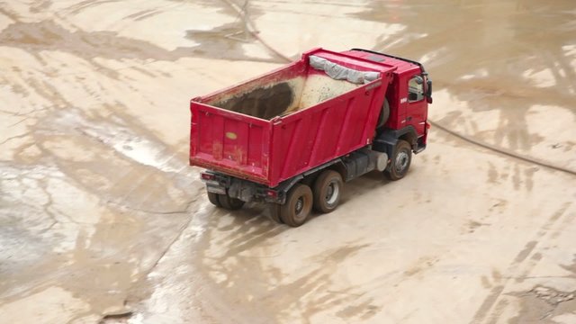 Empty tipper truck leaving from construction site