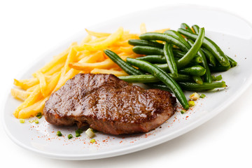 Grilled steak, French fries and green beans