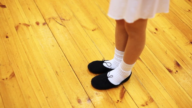 legs of girl doing ballet workout in movement while standing