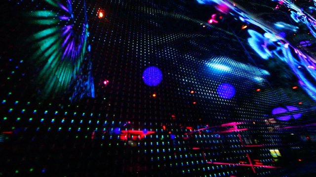 large LED screen with changing picture in nightclub, close-up