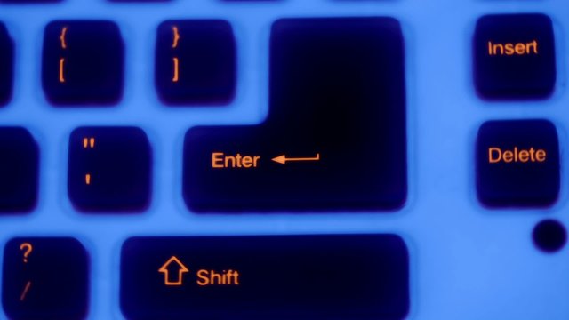 Buttons of keybord with blue backlight rotates in dark