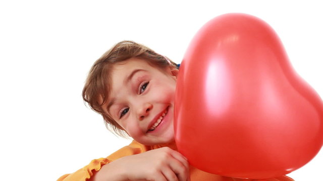 girl hiding behind big heart shaped balloon