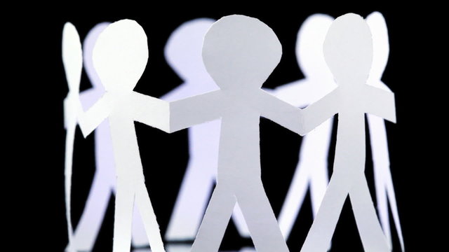 eight paper people stand in circle and hold hands, rotates